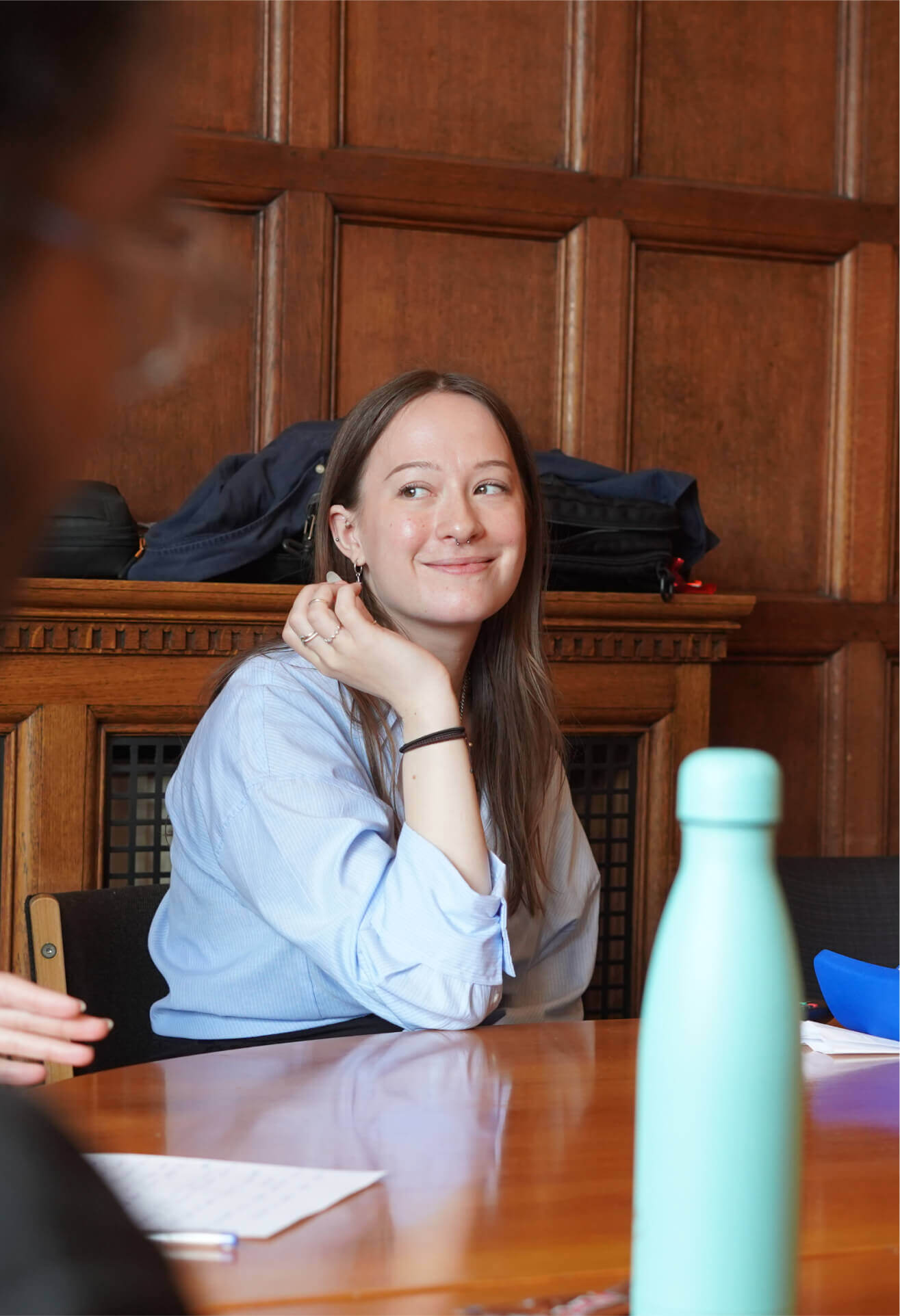 Articulate employee smiling at table