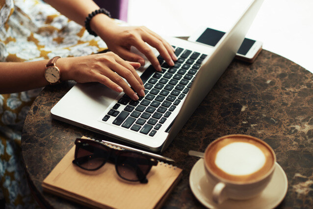 A copywriter using laptop in cafe