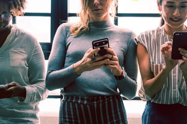 A group of people using smartphones