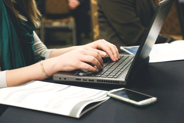 A copywriter working on a laptop